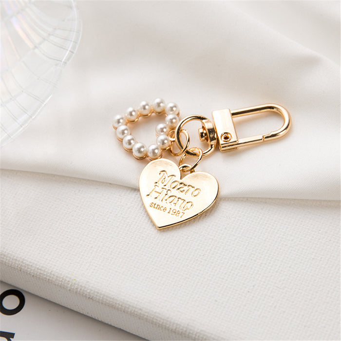 Wholesale Wholesale of metal keychains, cute shell key pendants, wholesale of bags and pendants, creative small gifts for gifting