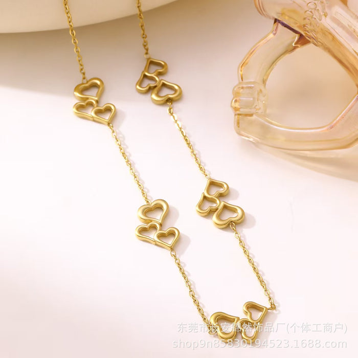 Wholesale Hollow out three-heart stainless steel necklace and bracelet set