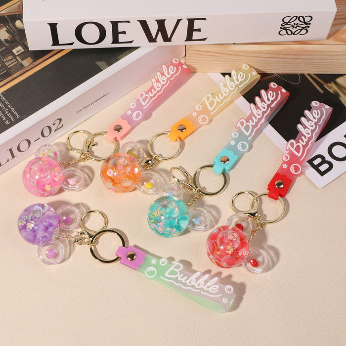 Wholesale quicksand bottle keychain wholesale floating liquid crystal key chain school bag pendant car keychain