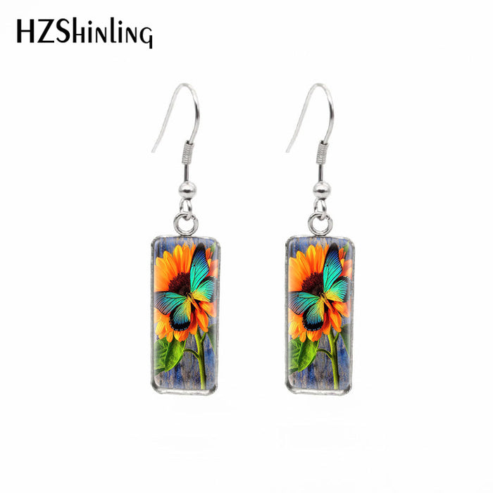 Wholesale Independently packaged hook flower pendant earrings, creative time gemstone earrings