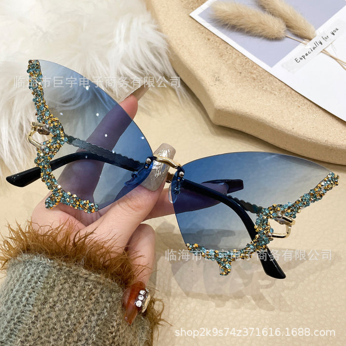 Wholesale Butterfly shaped diamond studded frameless sunglasses for women with fashionable personality and exaggerated sunglasses
