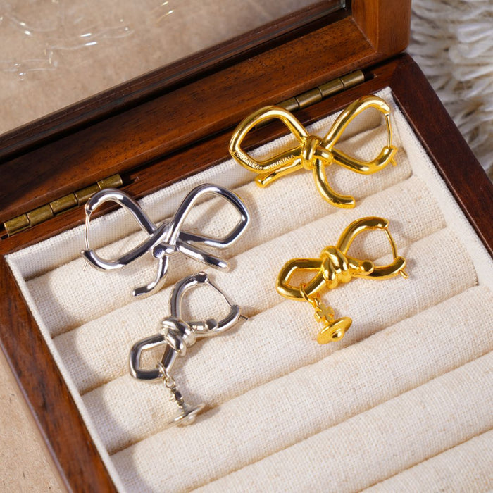 Wholesale Asymmetric bow, small Saturn, gold and silver earrings, niche design, light luxury