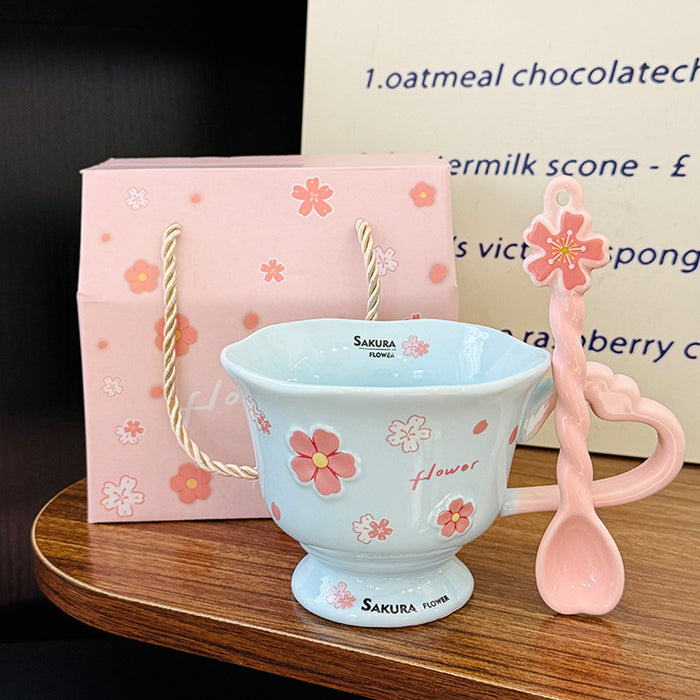 Wholesale Pink ceramic stemmed cup with cherry blossom relief design and spoon