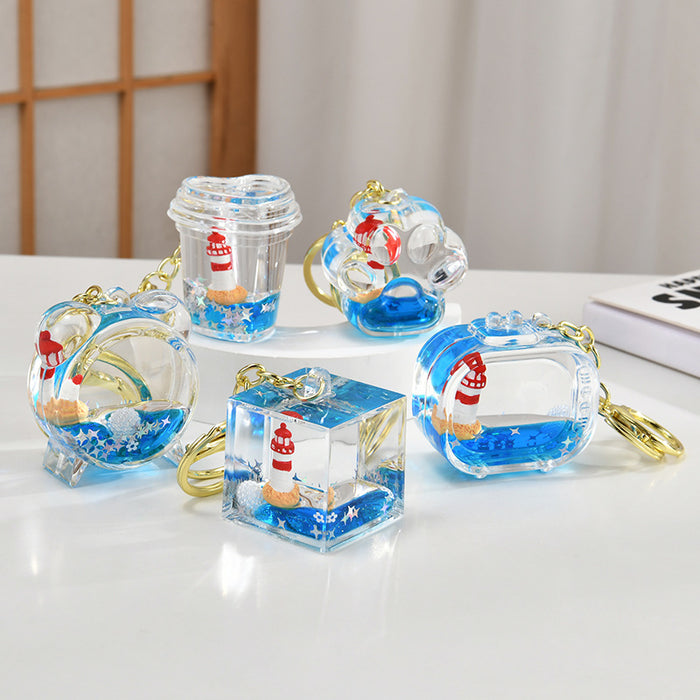 Wholesale Acrylic sailboat lighthouse blue oil-filled quicksand bottle keychain