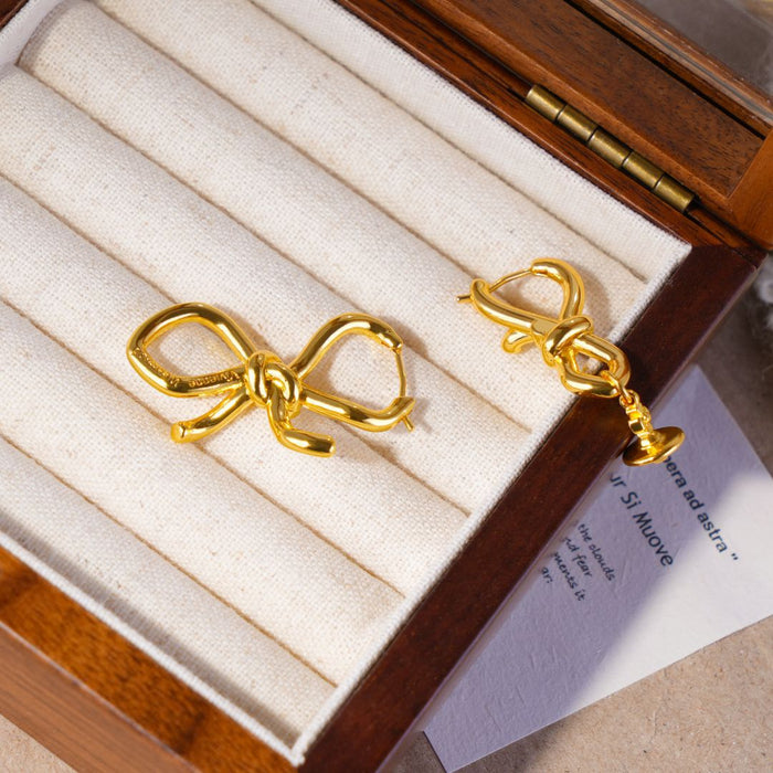 Wholesale Asymmetric bow, small Saturn, gold and silver earrings, niche design, light luxury