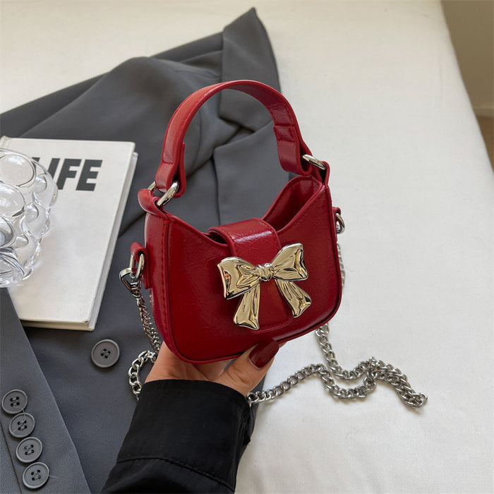 Wholesale New retro oil leather handbag with shiny bow and chain crossbody bag