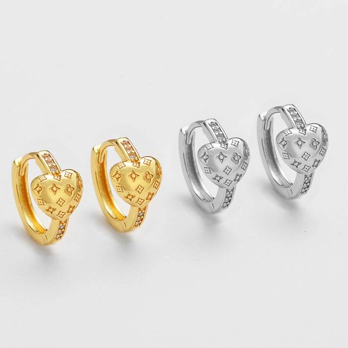Wholesale Zirconia-studded heart-shaped metal earrings with a patterned design.