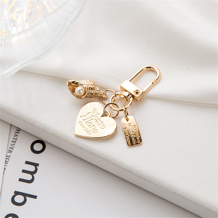 Wholesale Wholesale of metal keychains, cute shell key pendants, wholesale of bags and pendants, creative small gifts for gifting