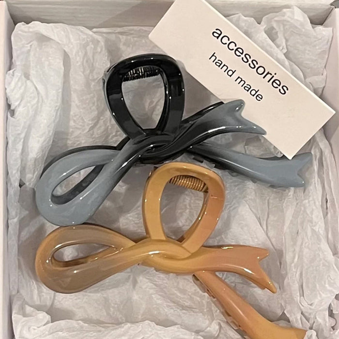 Wholesale Bow shaped acrylic hair clip for women's hair accessories with a high-end feel. Back of the head hair clip with a large shark clip