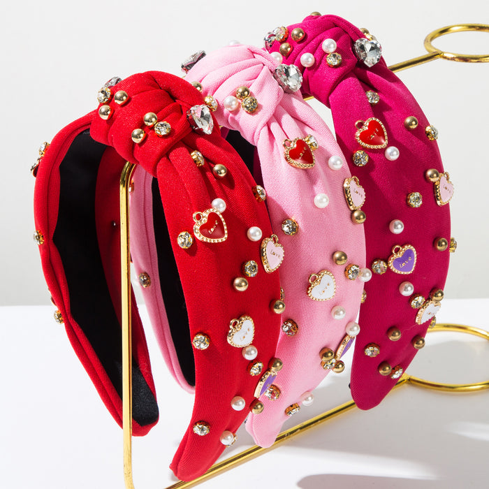 Wholesale Valentine' s Day headband with pearl-encrusted alloy letter and heart-shaped embellishments