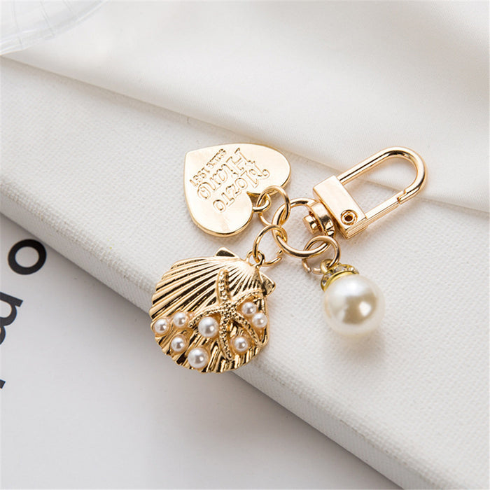 Wholesale Wholesale of metal keychains, cute shell key pendants, wholesale of bags and pendants, creative small gifts for gifting