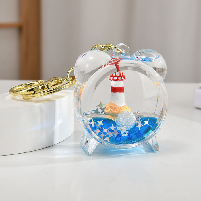 Wholesale Acrylic sailboat lighthouse blue oil-filled quicksand bottle keychain