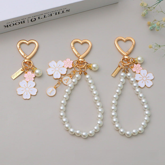 Wholesale Two tone flower alloy keychain pendant, cute letters, pearl accessories, headphone cover, bag, hanging decoration