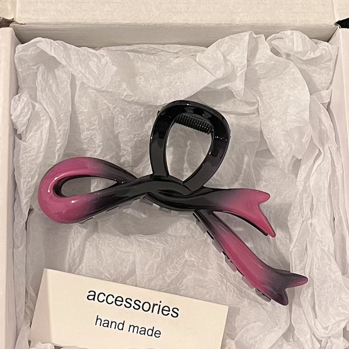 Wholesale Bow shaped acrylic hair clip for women's hair accessories with a high-end feel. Back of the head hair clip with a large shark clip