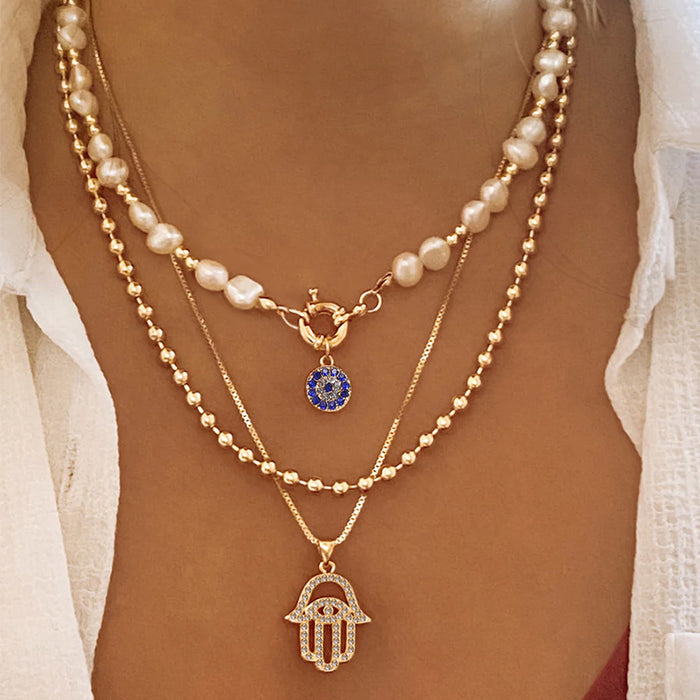 Wholesale New exaggerated jewelry alloy diamond inlaid multi-layer necklace for women, pearl eyes, palm pendant