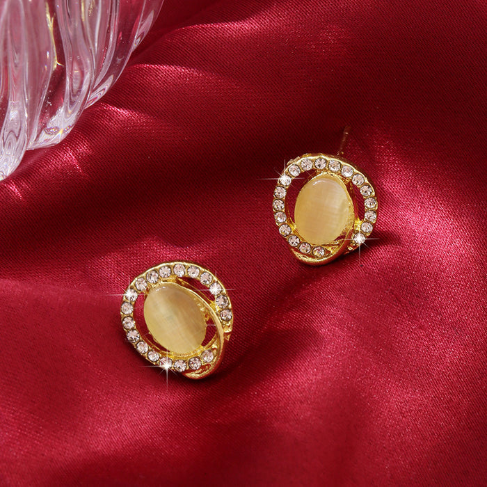 Wholesale Round cat eye stone earrings, simple and gentle sparkling diamond earrings, retro temperament, daily earrings
