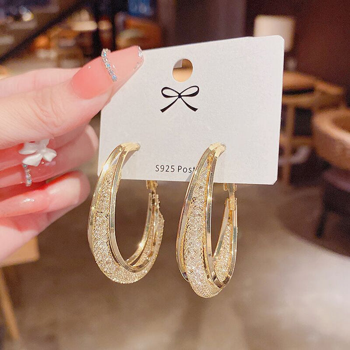Wholesale Metal earrings with hollowed out mesh and crystal circles, earrings with a subtle touch of elegance, and female earrings with inlaid details