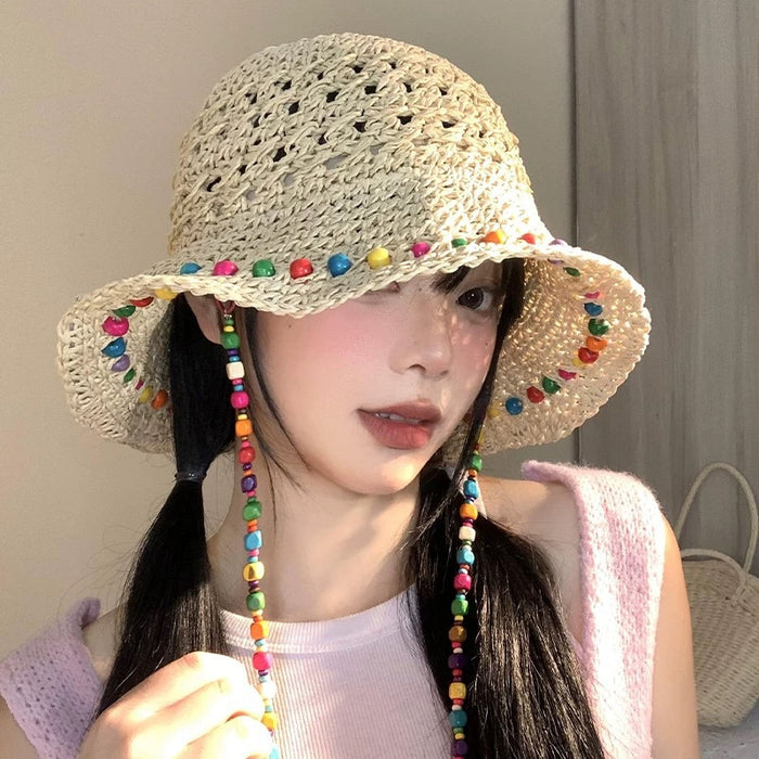 Wholesale Colorful wooden bead grass hat for women in summer with hollowed out large brim for sun protection and foldable fisherman hat