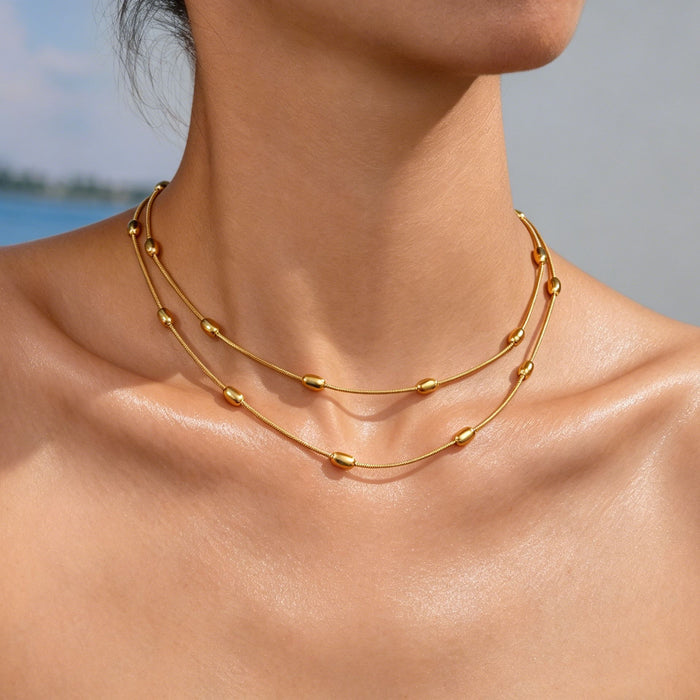 Wholesale 2pcs A luxurious double-layered gold bead snake bone necklace perfect for layering and exuding elegance
