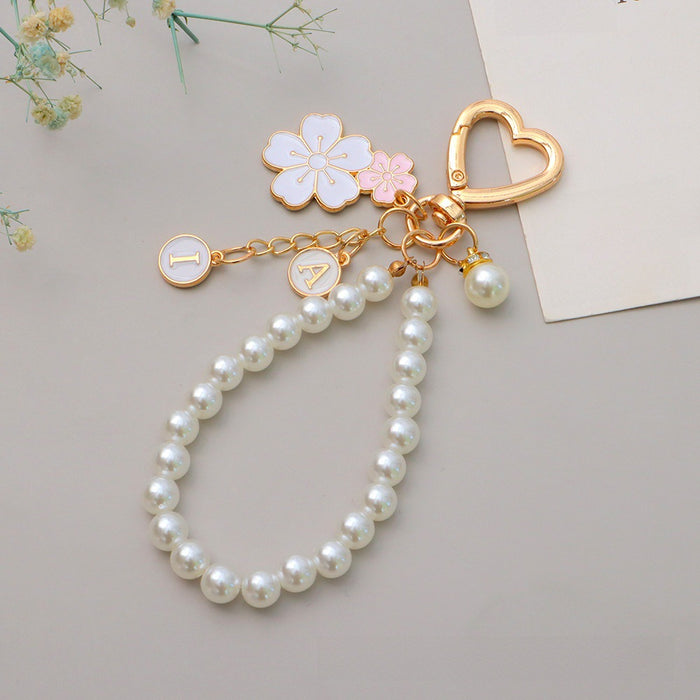 Wholesale Two tone flower alloy keychain pendant, cute letters, pearl accessories, headphone cover, bag, hanging decoration