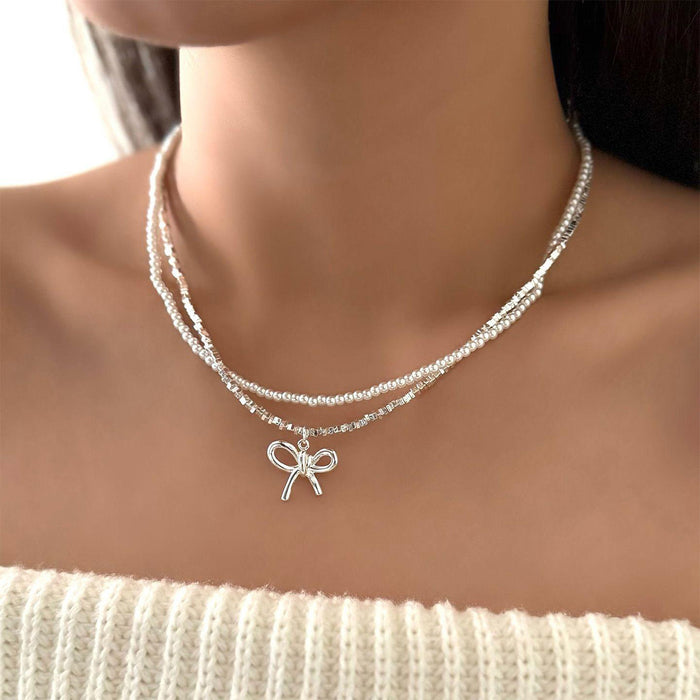 Wholesale Cross border new bow necklace with simple and high-end feel, retro double-layer layered design, imitation pearl collarbone chain