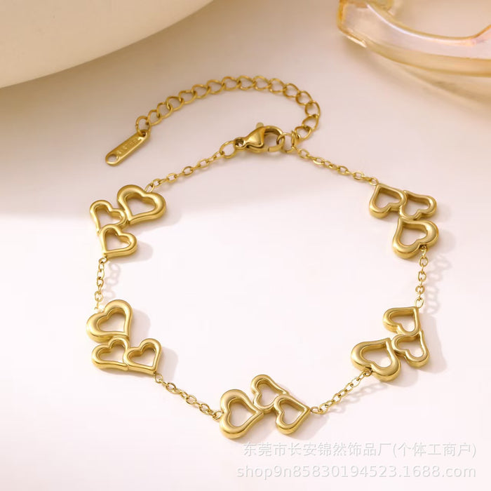 Wholesale Hollow out three-heart stainless steel necklace and bracelet set