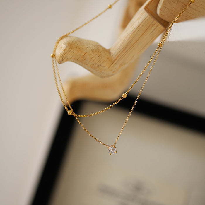Wholesale Exquisite single diamond small double-layer necklace, gold bead collarbone chain, titanium steel electroplating