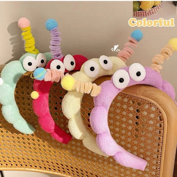 Wholesale Cute girl' s twistable hairband with big-eyed plush toy design.