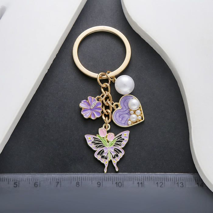 Wholesale Oil-dripping purple heart-shaped pearl tulip flower butterfly metal keychain