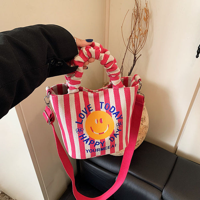 Wholesale Canvas bag, cute smiling face handbag, striped crossbody bag, commuting shoulder bag
