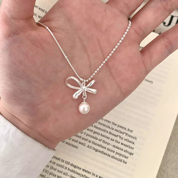 Wholesale New bow pearl pendant necklace with gentle and elegant temperament, light luxury and versatile collarbone chain